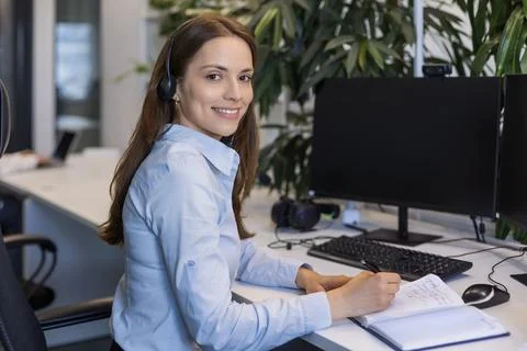Friendly and helpful customer service support specialists in work Stock Photos