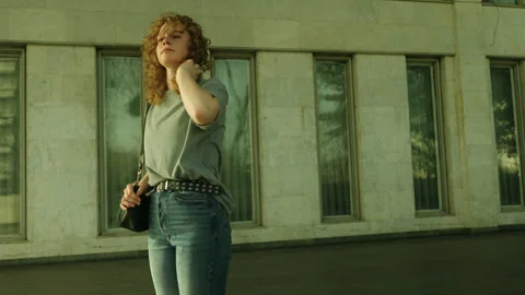 Friendly attractive young curly haired woman wearing t-shir, jenas, relaxing Stock Footage 271305811
