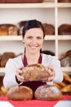 Friendly bakery assistant or worker Stock Photos