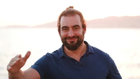 Friendly bearded man makes an army salutation to camera and laughs 스톡 동영상 160149320