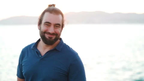 Friendly bearded man turns to camera, and starts laughing 스톡 동영상 160149345