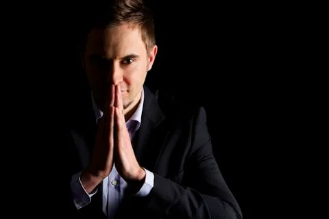 Friendly businessman with folded hands. Stock Photos