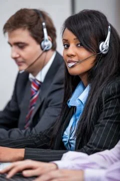 Friendly callcenter agent operator with headset telephone Stock Photos