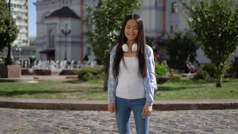 Friendly charming cute funny young student woman japanese looking at the camera Stock Footage 140056563