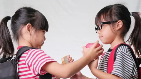 Friendly cheerful classmates sharing healthy meal.Concept of nutrition in school Stock Footage 171315711