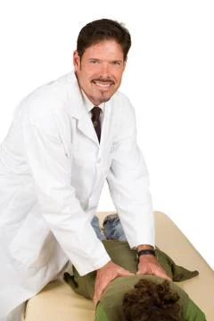 Friendly Chiropractor Gives Adjustment Stock Photos