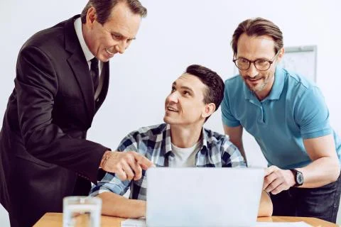 Friendly colleagues helping to solve the problem 스톡 사진