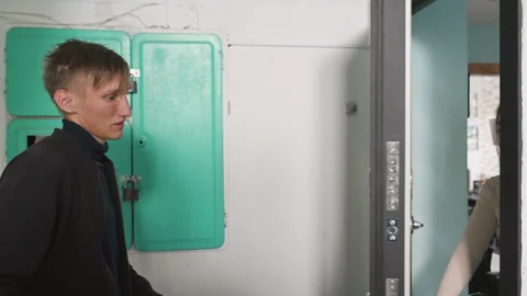 Friendly contactless package handoff, Courier delivers parcel to resident in Video stock 329577661