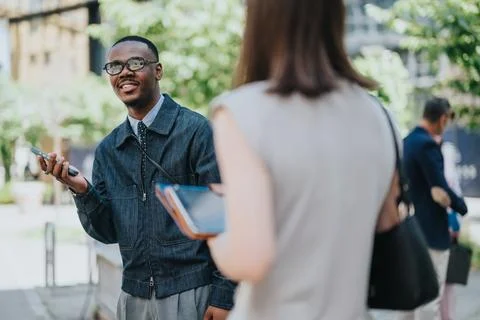 Friendly conversation between colleagues in a city outdoor professional setting Stock Photos