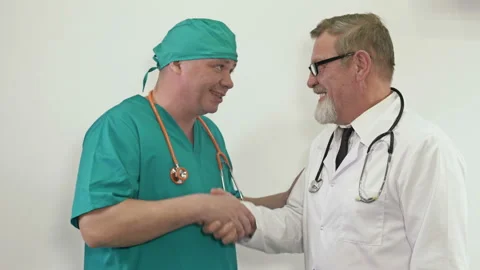 Friendly conversation between two doctors. Mutual respect and exchange of Stock Footage 150256633