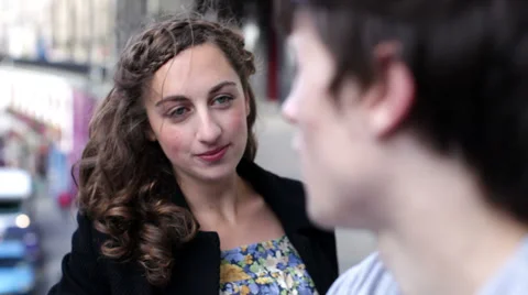 Friendly couple talking outside.  Girlfriend and boyfriend out and about in the Видео 32936751