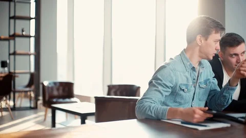 Friendly creative colleagues team discussing project or idea at the table Stock Footage 121556430