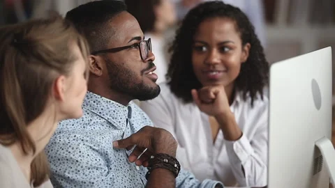 Friendly creative diverse colleagues team discuss online project use computer Stock Footage 134270512