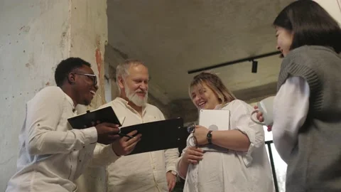 Friendly creative diverse colleagues team discuss startup project near wall Video stock 166060572