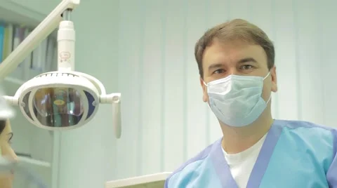 Friendly dentist smiling at camera at the dental clinic.  Packshot Stock Footage 48770353