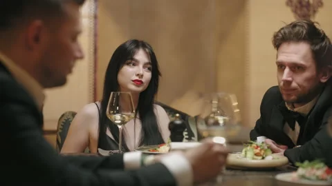 Friendly dinner in restaurant, men and their wives sitting at table and talking Stock Footage 227557340
