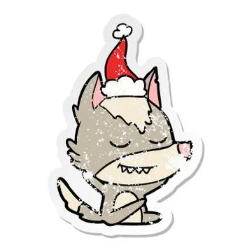 Friendly distressed sticker cartoon of a wolf sitting wearing santa hat 스톡 일러스트