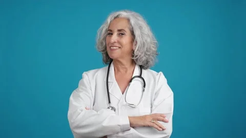 Friendly doctor posing with a lab coat and a stethoscope Видео 229548871