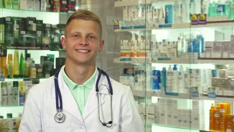 Friendly doctor presenting a package with a warm smile Stock Footage 311941065