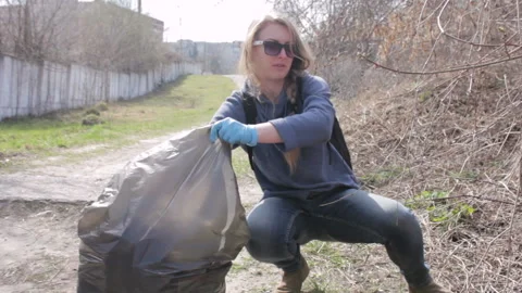 Friendly ecologists cleaning the garbage at park Stock Footage 113356467