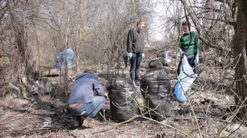 Friendly ecologists cleaning garbage at park. Timelapse Stock Footage 113356639