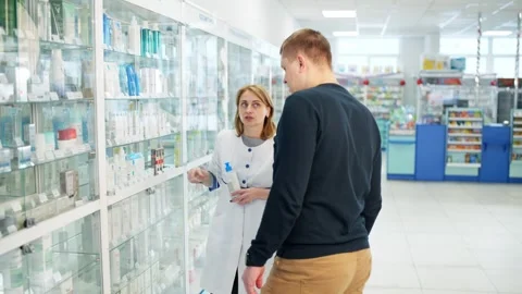 A friendly employee of the pharmacy advises the client. Stock Footage 263810014