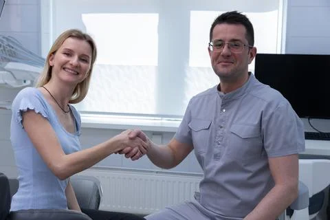 A Friendly Encounter Between a Patient and Dentist in a Modern Clinic Setting Stock Photos