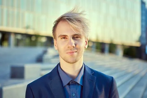 Friendly face of young businessman in front of an office building. 写真素材