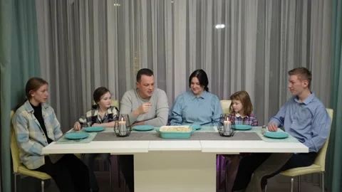 A friendly family is sitting at the table Stock Footage 234696293
