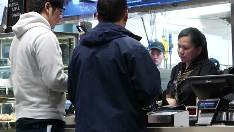 Friendly Female Cashier Taking Orders from Customers at Cafe Counter Stock Footage 342278739