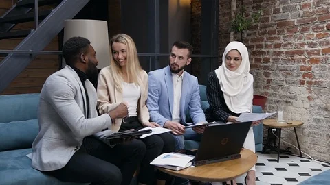 Friendly of four multiethnic colleagues team discuss important matter project Stock Footage 121518308