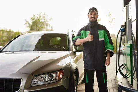 Friendly gas station worker gesturing thumb up Stock Photos