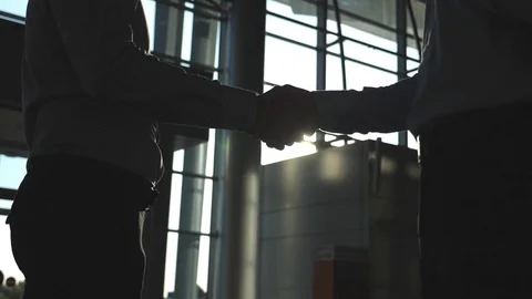 Friendly handshake of two businessmen greeting each other in office. Business Stock Footage 80332307