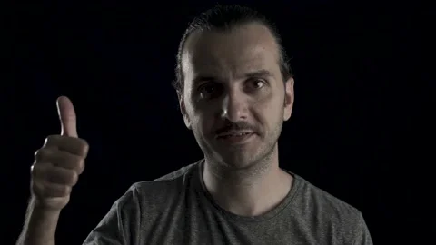 Friendly handsome guy's face portrait in black background, studio shot. Man i Stock Footage 133415627