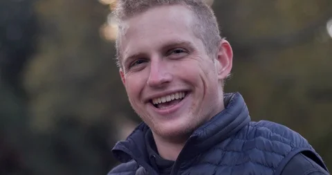 Friendly, happy, attractive young man turning, smiling and looking at the camera Video stock 104579181