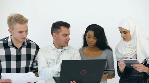 Friendly high-spirited multiethnic corporate coworkers working with computer Stock Footage 121833823
