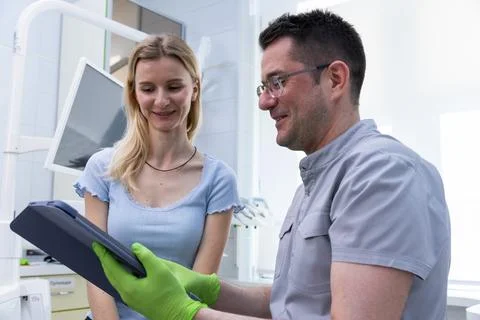 A Friendly Interaction Between a Patient and a Dentist in a Modern Dental Clinic Stock Photos