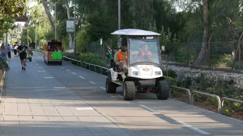 Friendly Maintenance Men in Golf Cart Giving in 4K Stock Footage 53430644