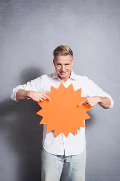 Friendly man presenting empty signboard with space for text. Stock Photos