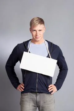 Friendly man presenting white empty signboard. Stock Photos