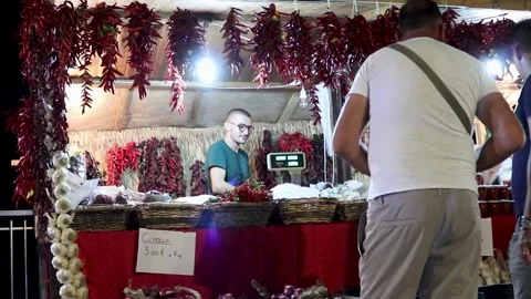 A friendly man in a shop at a pepper mill communicates with a customer. Stock Footage 223663789
