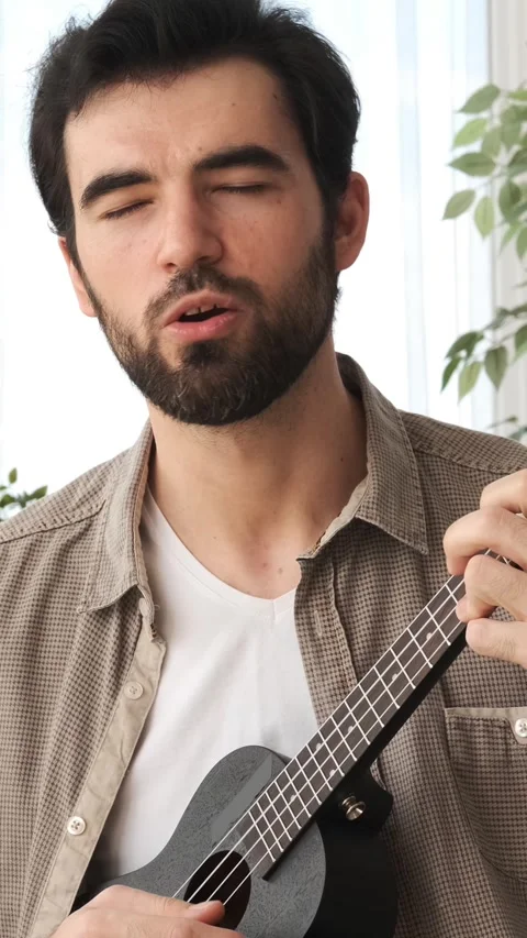 Friendly Man Singing With Ukulele At Home Stock Footage 310460083