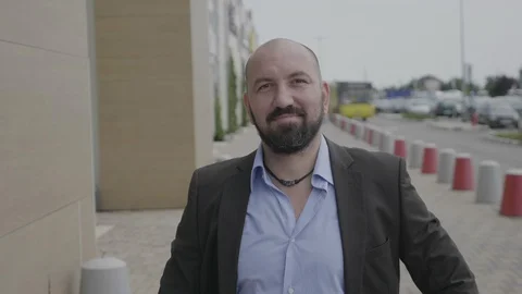 Friendly man in suit waving his hand saying hello with positive confident smi Stock Footage 95979071