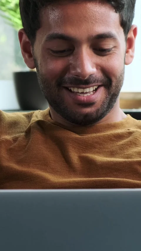 Friendly Man Surfing Internet Using Laptop And Laughing At Home Video stock 284313582