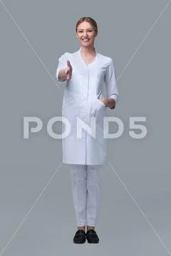 Friendly medical doctor woman stretching hand for handshake. isolated on white Stock Photos