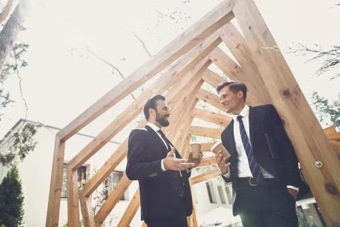 Friendly men drinking coffee outdoors and talking Stock Photos