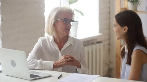 Friendly old manager teacher mentor consulting young client student intern Video stock 107724124
