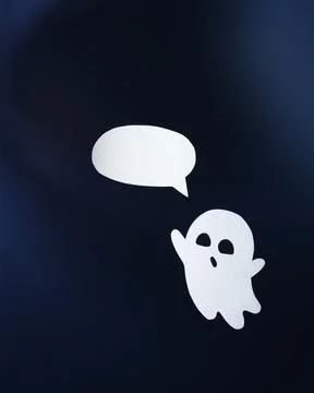 Friendly paper ghost with a bubble for text on an blue background 스톡 사진