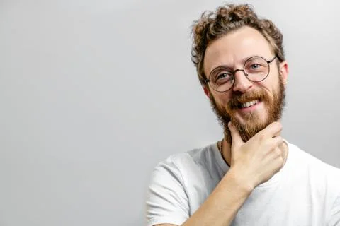 Friendly positive man looking at camera with doubting, questioning expression. Stock Photos