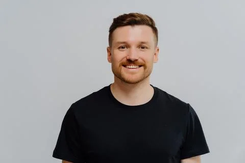 Friendly positive man smiling at camera and enjoying life Stock Photos